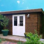 Brown wooden summer house with a flat roof